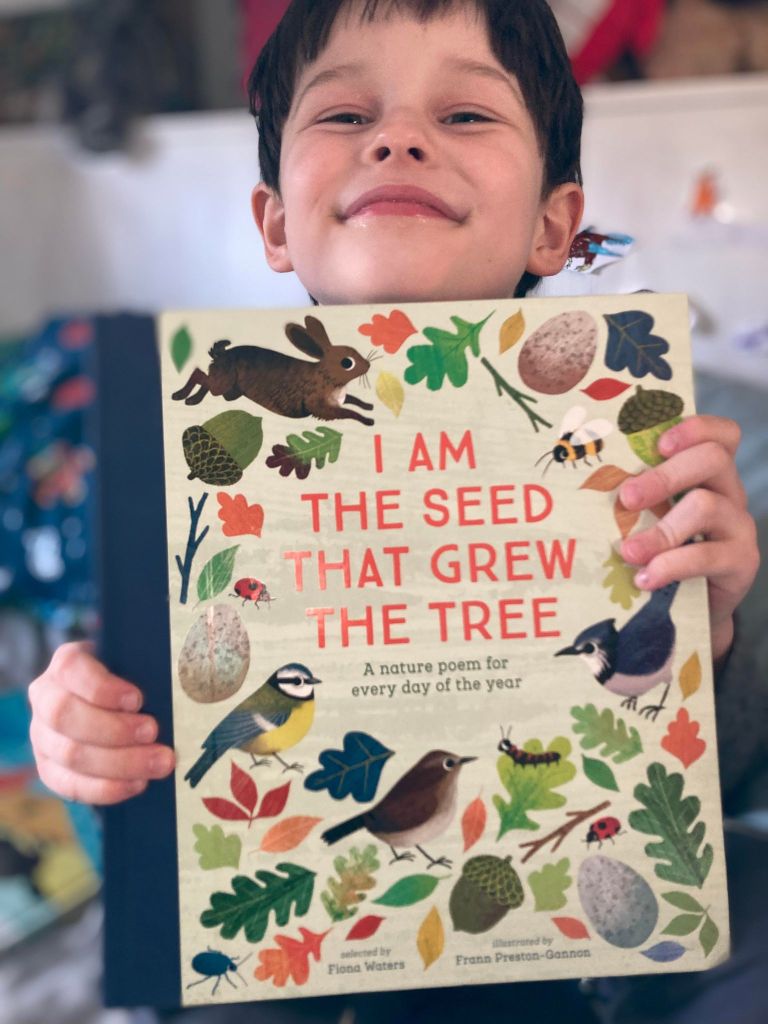 Noah holding I am the seed that grew the tree.